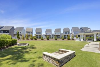 a park with a row of houses in the background